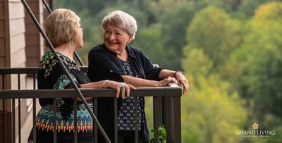 Two residents enjoying conversation on a balcony