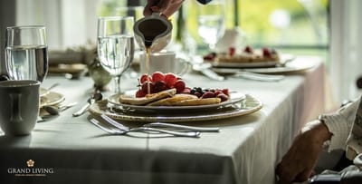 Close-up of residents enjoying a meal with pancakes and berries