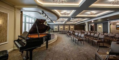 Interior view of a common area with a piano and seating