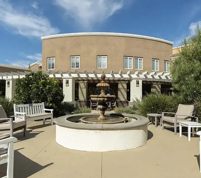 Outdoor seating area with fountain and landscaping