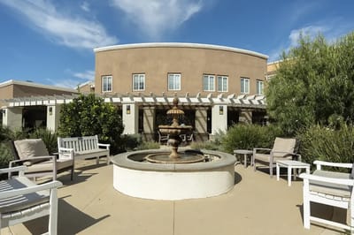 Outdoor space with a fountain and seating area
