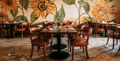 Dining area with sunflower mural and decorated tables