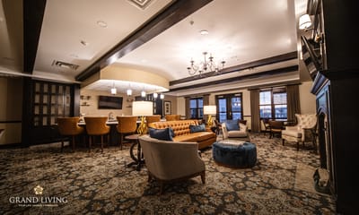 Common area with seating and decor in a senior living facility