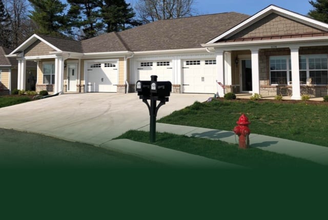 Exterior view of a senior living facility with garden