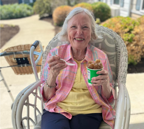 A cheerful resident enjoying ice cream outdoors