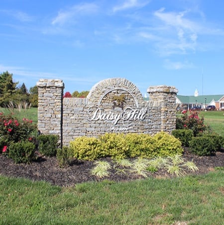 Stone sign for Daisy Hill Senior Living surrounded by landscaping