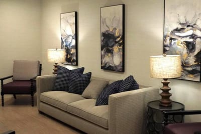 Cozy lounge area with artwork and lamps