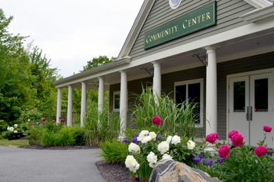 Exterior view of the Community Center with flower beds