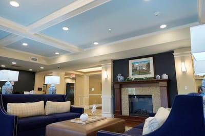 Bright lounge area with comfortable seating and fireplace