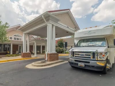 Exterior view of Charter Senior Living building with transport vehicle