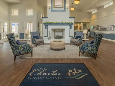 Interior of a cozy common area with floral chairs
