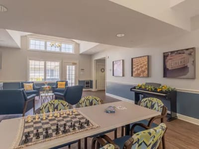 Bright common area with seating and a chessboard