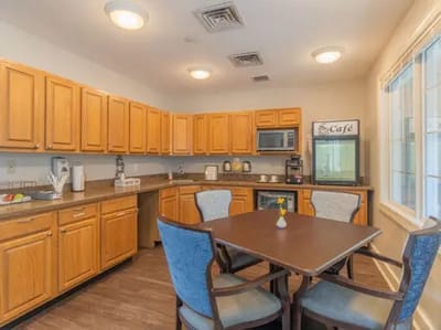 Bright kitchen area with wooden cabinets and a table