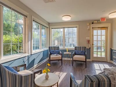 Bright common area with seating and large windows