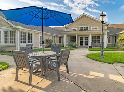Outdoor seating area with an umbrella and building in background
