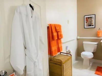 Bathroom interior with towels and robe