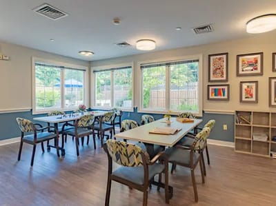 Bright activity room with large windows and tables