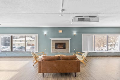 Bright common area with seating and fireplace