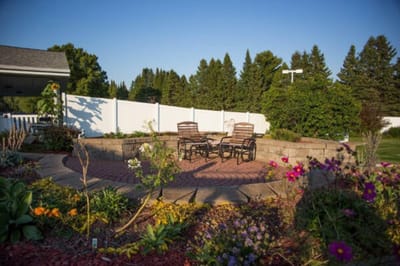 Outdoor seating area surrounded by colorful flowers