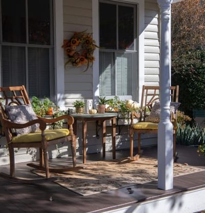 Cozy outdoor seating area with rocking chairs and plants