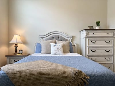 Cozy private resident room with a bed and dresser