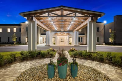 Entrance to Claiborne at Gulfport Highlands with landscaped pathway