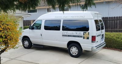 Facility transport van parked in front of building