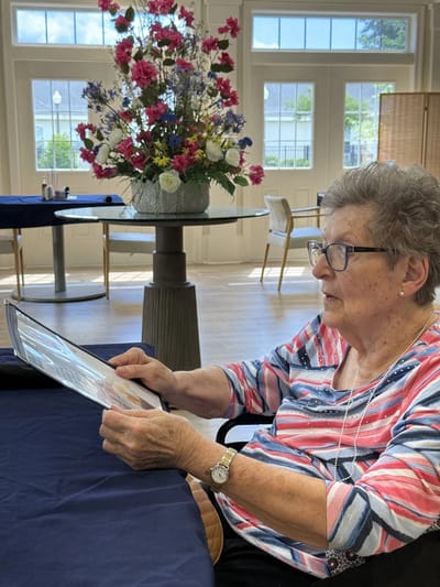 A resident reading a menu in a well-lit dining area