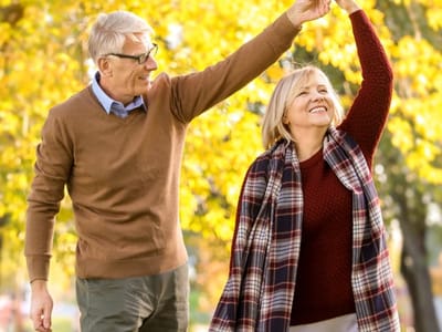 A happy couple enjoying a walk in a park