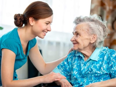 Staff member interacting with a resident in a care setting