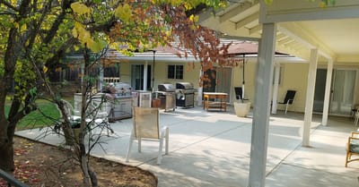 Outdoor patio area with seating and grills