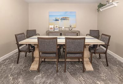 Dining area with a large table and chairs.