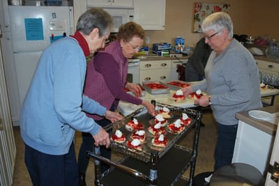 Residents preparing food in a kitchen
