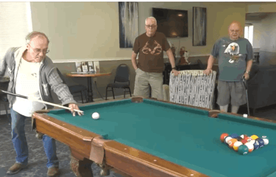 Residents playing pool in a common area