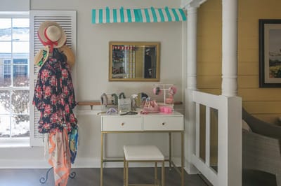 Decorative entryway with hats and floral items