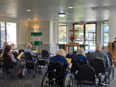 Residents attending church service in a common room