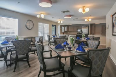 Dining area set for a meal with blue napkins