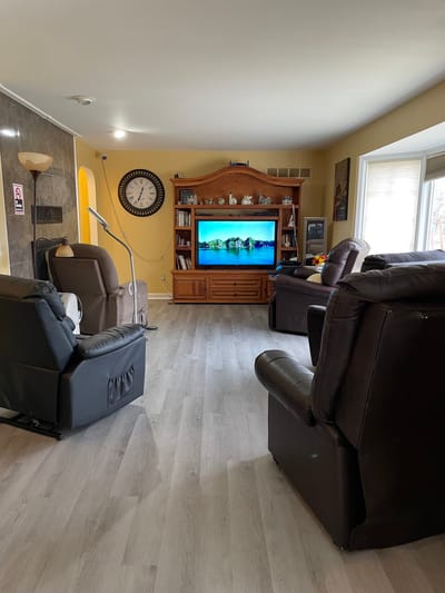 Spacious common area with comfortable seating and a television