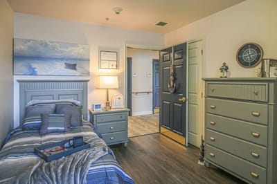 Cozy resident room with bed and dresser