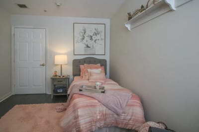 Cozy bedroom with a pink theme and floral artwork
