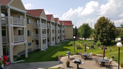 Exterior view of a senior living facility with gardens