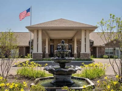Exterior view of the facility with fountain and flag