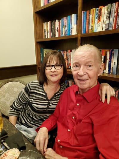 Resident and caregiver in a cozy library setting
