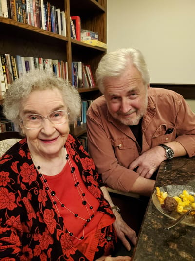 Resident and staff member smiling together