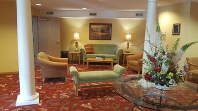 Cozy common area with seating and floral arrangement