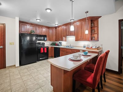 Good Samaritan Society – Grand Island Village, nursing home in Grand Island, NE — Modern kitchen with wooden cabinetry and dining area