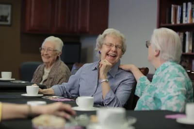 Residents enjoying tea and conversation in a common area