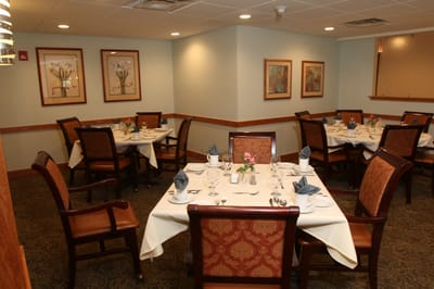 Dining room set up for a meal with floral decorations