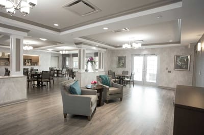 A cozy common area with seating and dining tables