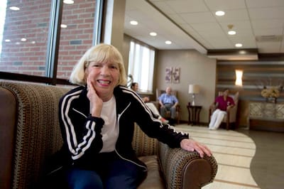 A resident smiling in a common area of the facility